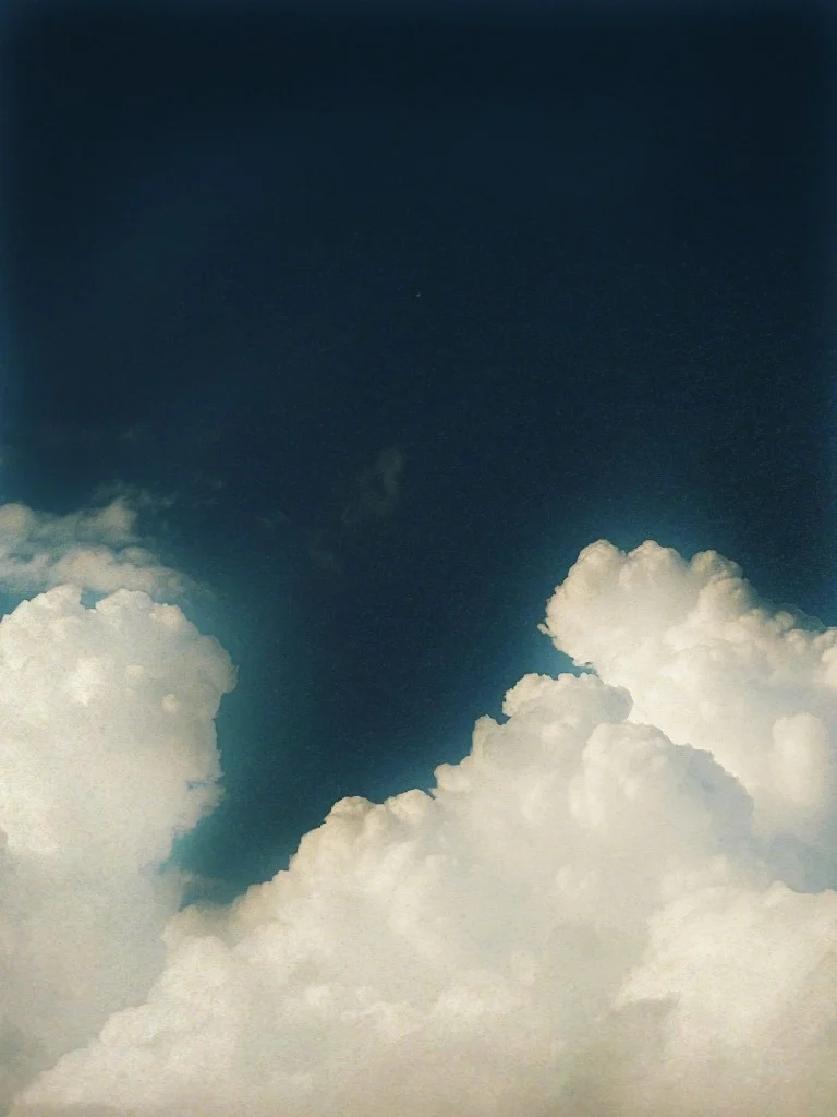 Cumulus clouds under a deep blue sky, on Fujicolor Natura 1600